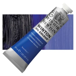 A tube of French Ultramarine Winsor and Newton Winton Oil Paint 37ml is shown diagonally, across the center of the frame. The tube is a silver colour and has a white screw on, plastic lid. The Winsor and Newton logo is printed at the top of the tube and there is a white band printed across the tube, below the logo, that has the words 'Winton Oil Colour' written on it. Below that is a colour band printed across the tube that has black text describing the product colour and paint properties. There is a rectangular colour swatch behind the tube that shows the colour of the paint. It lays horizontally across the top third of the frame. The image is center of the frame and on a white background.