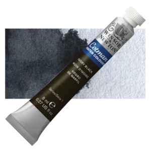 A single Ivory Black Winsor and Newton Cotman Watercolour 8ml Tube is shown diagonally across the frame. The back of the tube is facing the bottom left hand corner of the frame and the lid of the tube is facing the top, right hand corner of the frame. The tube is silver and the Winsor and Newton logo is printed at the top of the tube. There is a blue band below the logo and the words 'Cotman Watercolour' are printed on the blue band in white. Then there is a large colour band around the base of the tube that denotes the colour of the paint. The tube colour and paint properties are indicated on this colour band in black text. The tube has a white, plastic screw on cap. There is a rectangular colour swatch behind the tube that shows how the colour works on a gradient scale. The entire image is center of the frame and on a white background.