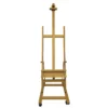 A single Prime Art Wooden Studio H-Frame Beech Easel with Wheels is shown in the center of the frame. It is a view of the front of the easel. The easel is made of a light beech wood and the castor wheels are black plastic. On a white background.