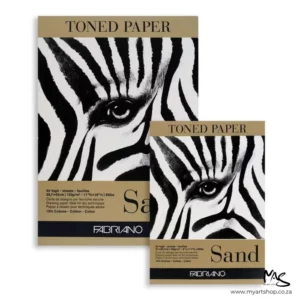 There are two different sized Sand Fabriano Toned Paper Pads in the frame. The back pad is bigger than the top pad. They have a coloured tab along the top and bottom of the cover of each pad that indicates the colour of the papers inside. There is a large image of a close up of a zebras eye on the cover of each pad. The image is center of the frame and on a white background.