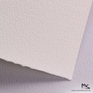 A close up of a corner of a sheet of White Fabriano Cromia Paper can be seen filling the frame. You can see a slight texture in the paper. The image is cut off by the frame.