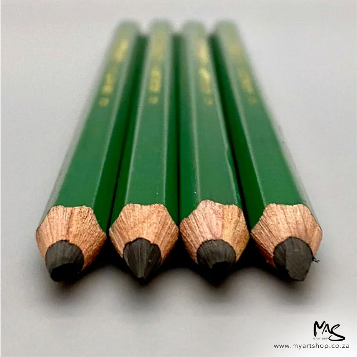 9xxb-kimberley-drawing-pencil-general-pencil-co-02 Four 9XXB Kimberley Drawing Pencil from the General Pencil Co. are shown laying on a surface. The image is taken of a close up of the pencils from the lead tips and the back of the image is blurred. The pencils have a green barrel and are on a light grey background.