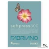 A Medium Prime Art Fabriano Soft Press Pad is shown in the center of the frame. The image is of the pad cover. The pad has a dusty blue cover with a picture of a pink flower and a butterfly on the cover. There is white and blue text below the image that describes the quality of the pad and has the brand name. The image is center of the frame and on a white background.