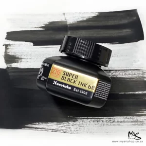 A single bottle of ZIG Cartoonist Super Black Ink can be seen in the center of the frame. The bottle is black with a black plastic screw on lid. There is a label around the body of the bottle which has black text and the ZIG logo. There is a black ink mark in the background and the bottle is angled on top.