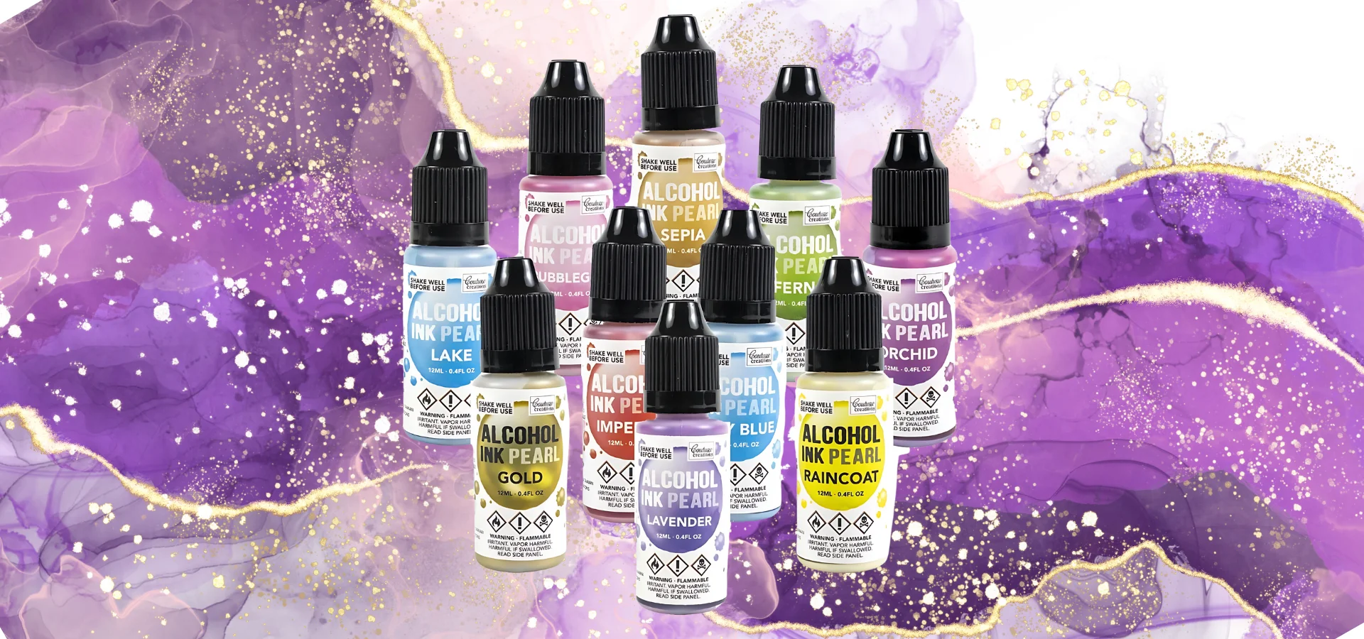 couture-creations-alcohol-ink-pearls shows in this image in the center a grouping of all the alcohol ink pearls in a circle all label facing forward. the bottles have the colour and product name clearly visable on it. they all have black lids. they are sitting infront of a purple shimmer background