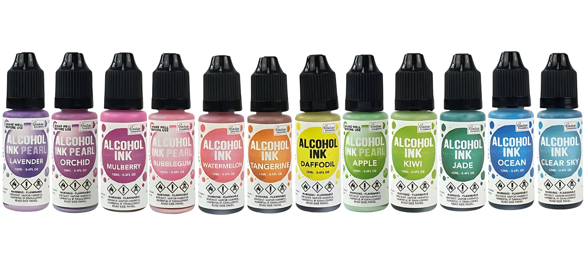 Couture Creations Alcohol Inks: Discover Vibrant Colors. shows in the image a line up of the couture creations alcohol inks in a row. they are in a rainbow order of colours. they have white bottles with coloured labels showing what the colour inside will look like. they all have black lids. they are on a white background