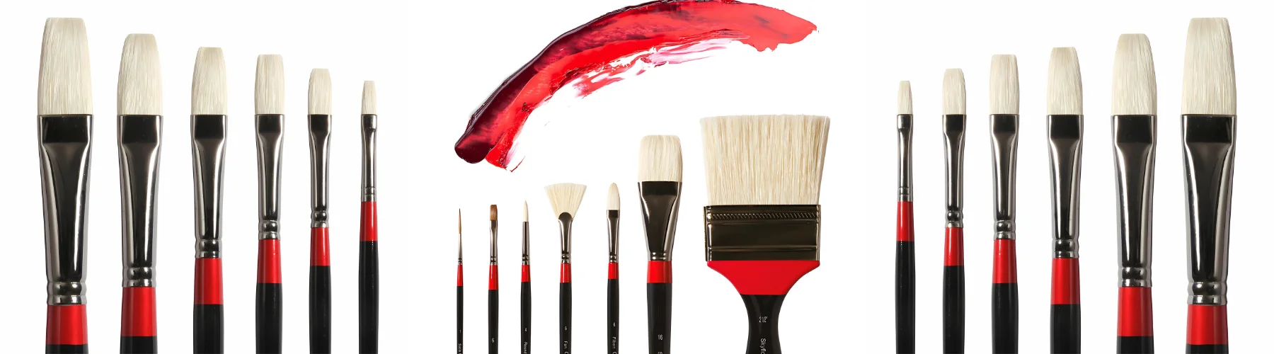 daler-rowney-georgian-brushes. on either side of the image is a duplicate picture of a range of brushes that are flat and are ranging from large to small in size of bristles. they are white hair with silver ferrules and red and black stems. in the sntre there are a variety of brushes from tiny to a large wash brush all white hair, silver ferrule and red and black stems. above them is a swipe of red paint in a half moon shape. all on a white background
