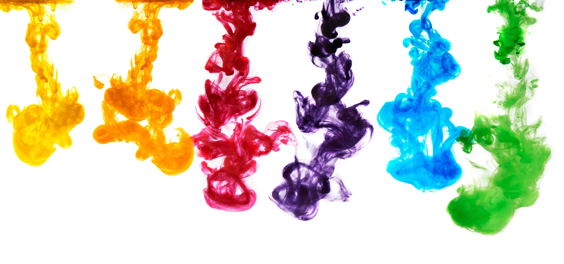 Speedball Acrylic Ink Magic Revealed. in this image across the top there is a line of colours. they are in rainbow order. there is a small white space inbetween each colour. each colour looks like a drop of ink that has been released into water. flowing down the image. on a white background