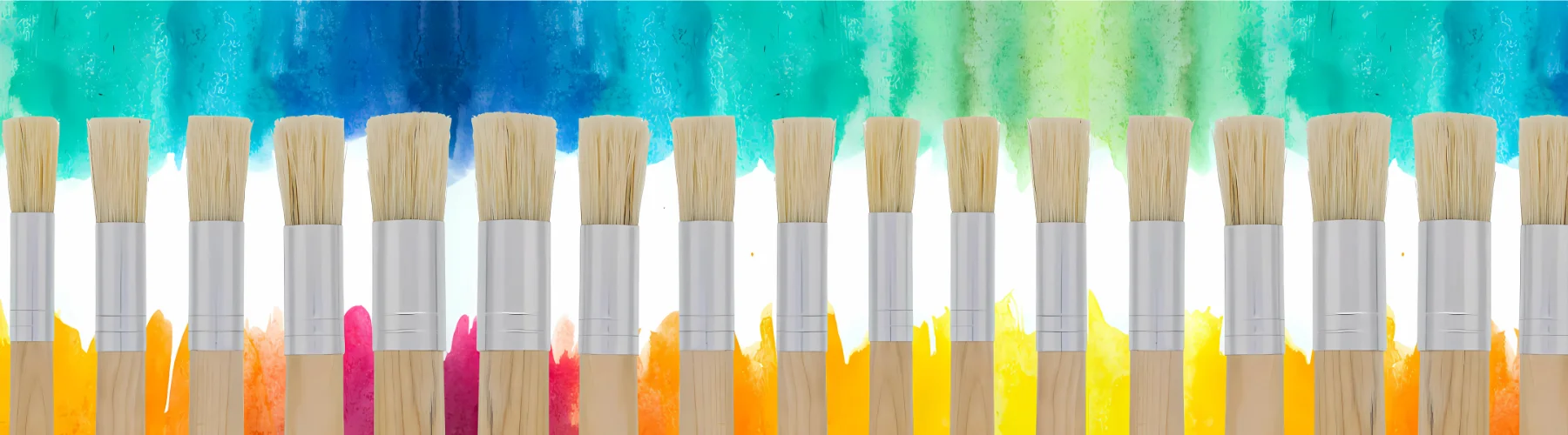 exploring-stippling-brushes-take-your-art-to-the-next-level. across the bottom of the image are a row of different sized stippling brushes. all facing hair upwards. they haive brown handles and silver ferrules with hog hair that is short and stumpy. they are sitting infront of a rainbow background.