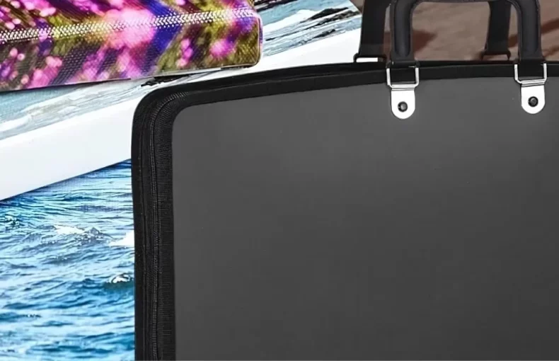 art-portfolio-cases-armor-up-your-artistry. the image is a close up of a portfolio bag that is closed and on the right hand side. the left hand side has three different canvases with images painted on it