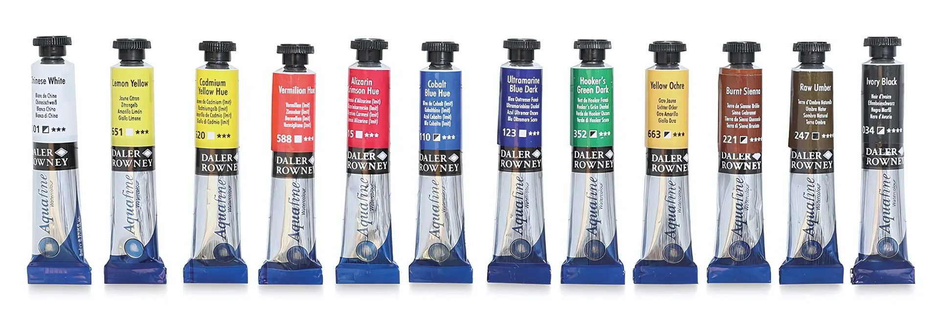 daler-rowney-watercolour-paints. are shown in the center of the image and they are all standing in a row with their caps at the top. all the caps are black and the tubes are silver at the bottom with the name written in blue and on the top of the tube is a colour band of the colour that is inside of the tube. they are in a rainbow order and on a white background
