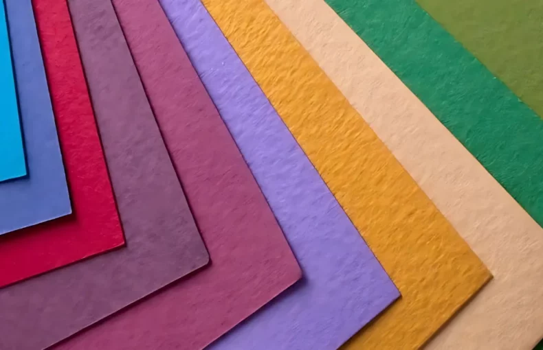 fabriano-tiziano-pastel-paper-a-colourful-journey. the image is a close up of various fabriano papers that are fanned out to see the different colour options that are available. the are coming in from the left hand side and pointing to the right hand side.