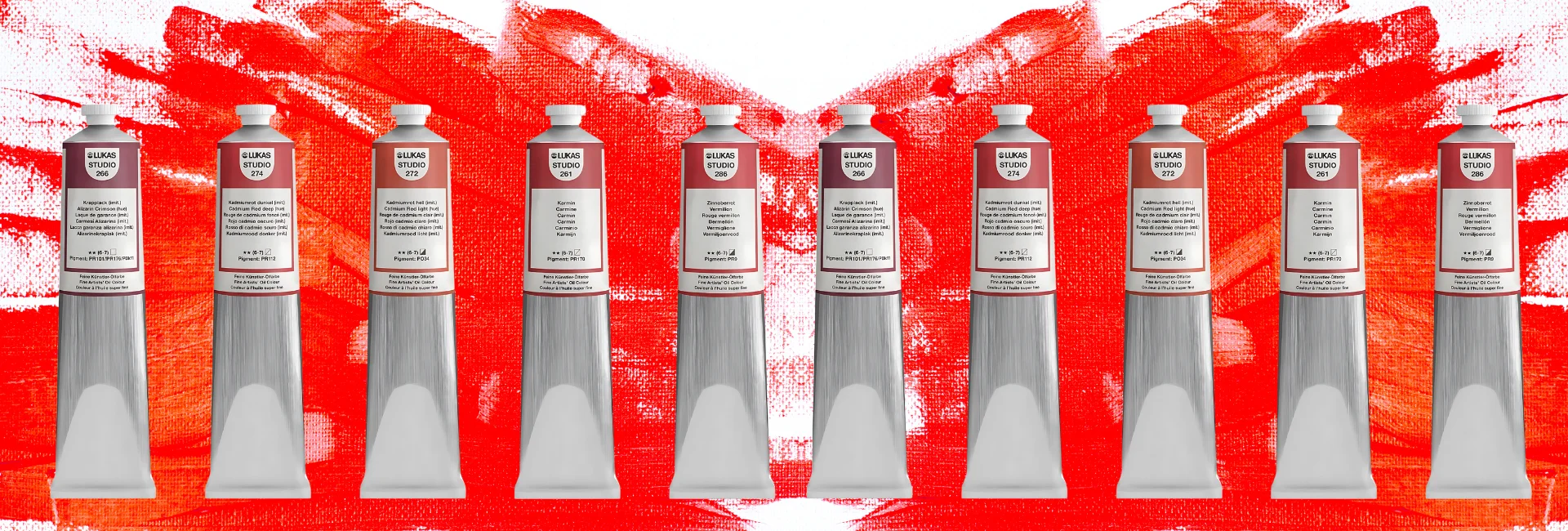 lukas-studio-oil-paint-paint-like-a-pro. the background is white with red paint roughly painted on it. infront of that is a line of lukas studio paints all lined up with their tubes silver and white caps facing the top of the image. they are all shades of red oil paint