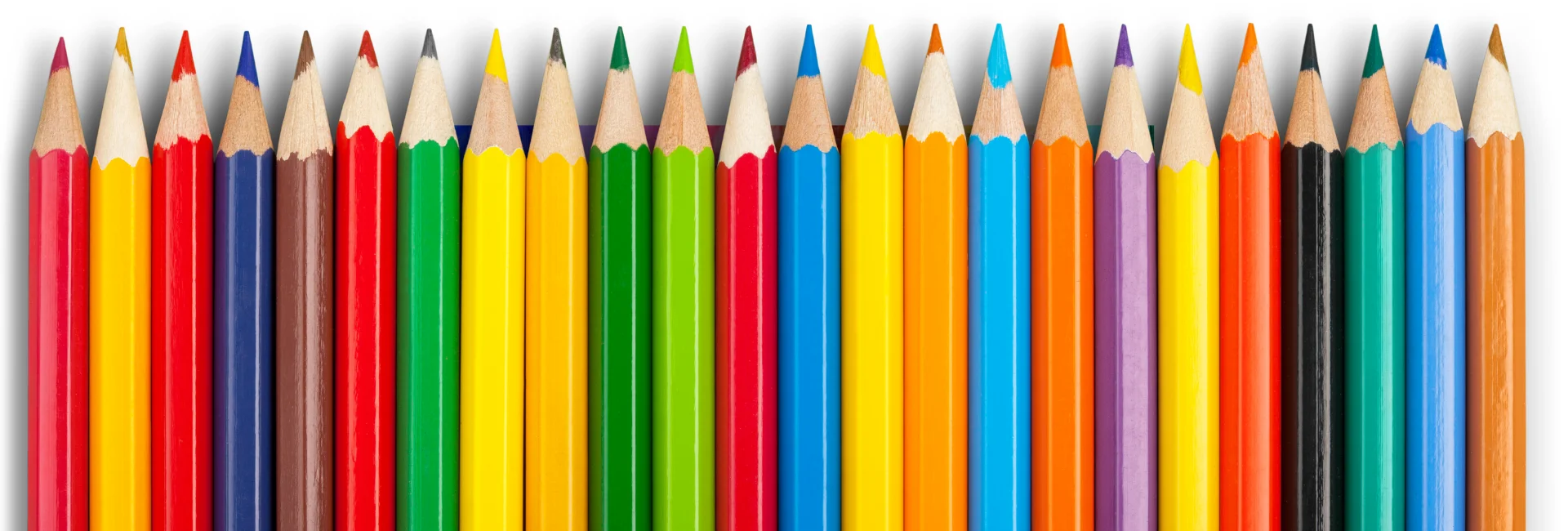 pastel-pencil-sets-an-exploration. the image shows a binch of brightly coloured pencils in a row in a rainbow order. they are all nib facing towards the top of the image. they are in a bunch of different colours and look sharp and neat