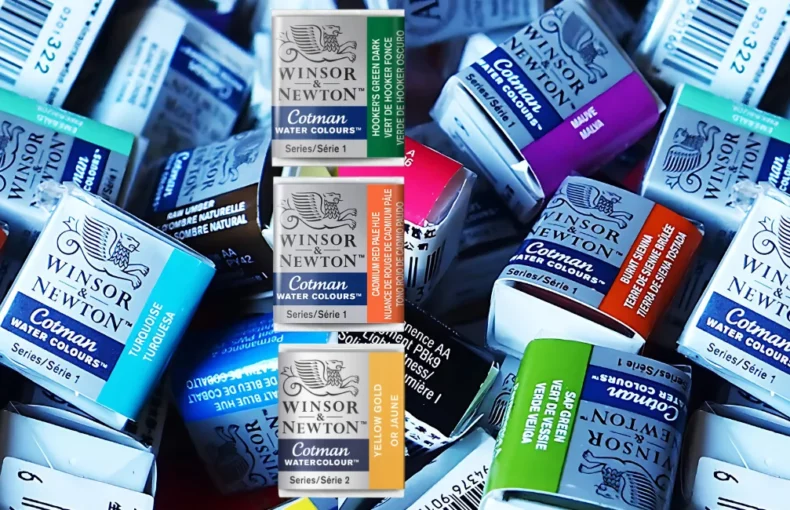 winsor-and-newton-cotman-watercolour-half-pans-colour-your-world. the image shows two duplicated images of a pile of cotman pans and in a big pile and in a variety of colours. in the center are three induvidual pans in a row. a green, orange and yellow.