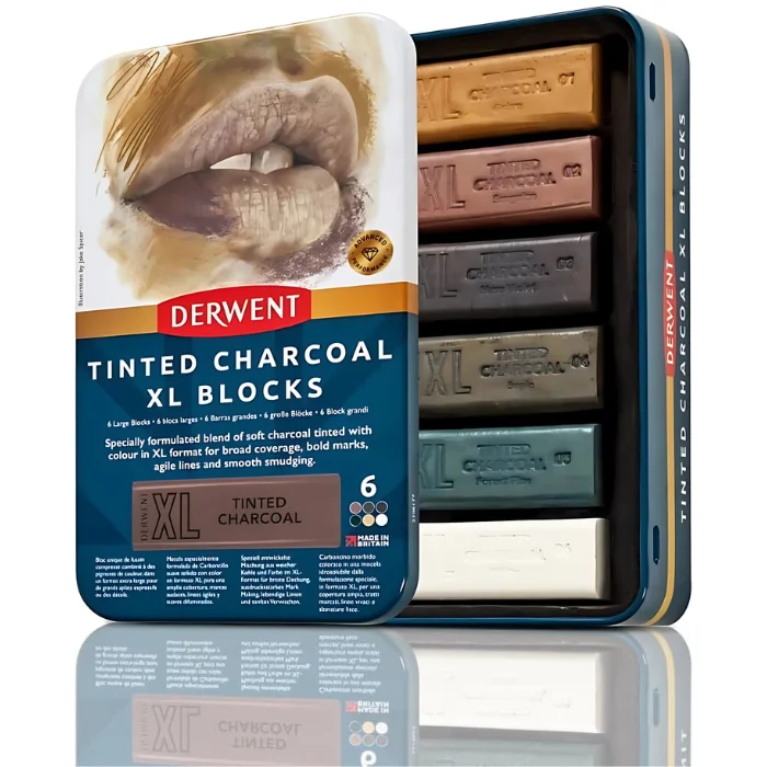 A single Set of 6 Derwent Tinted Charcoal XL Blocks is shown vertically in the center of the frame. The tin has a picture of a persons lips at the top of the tin and the bottom of the tin is blue with white text and has the details of the set printed on it. The Derwent logo is printed in red